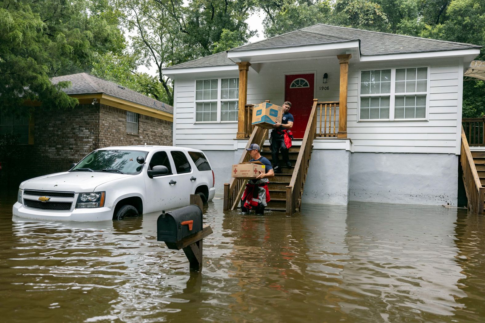 Firefighters in Savannah, Georgia, carry food to residents in the flooded neighborhood of Tremont Park on Tuesday, August 6. Since crashing into Florida as a Category 1 hurricane on Monday, <a href="index.php?page=&url=https%3A%2F%2Fwww.cnn.com%2F2024%2F08%2F08%2Fweather%2Ftropical-storm-debby-landfall-forecast-thursday">Debby has dumped more than a foot of rain</a> over parts of Florida, Georgia, South Carolina and North Carolina.