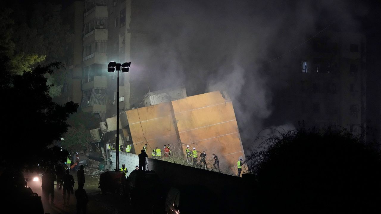 Rescuers arrive at the site of an Israeli airstrike in Beirut's southern suburbs, Friday, Sept. 27, 2024.