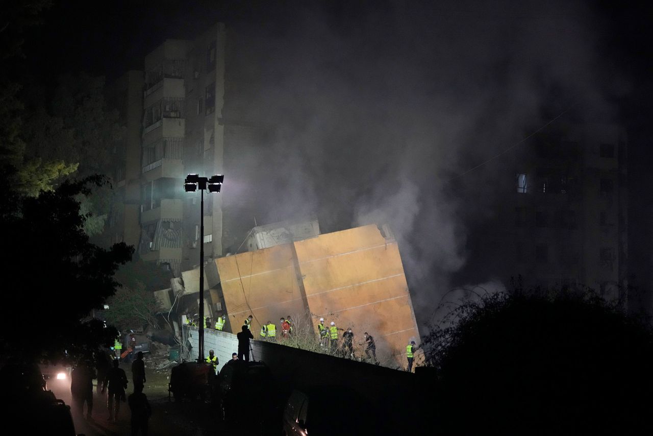 Rescuers arrive at the site of an Israeli airstrike in Beirut's southern suburbs, Friday, Sept. 27, 2024.