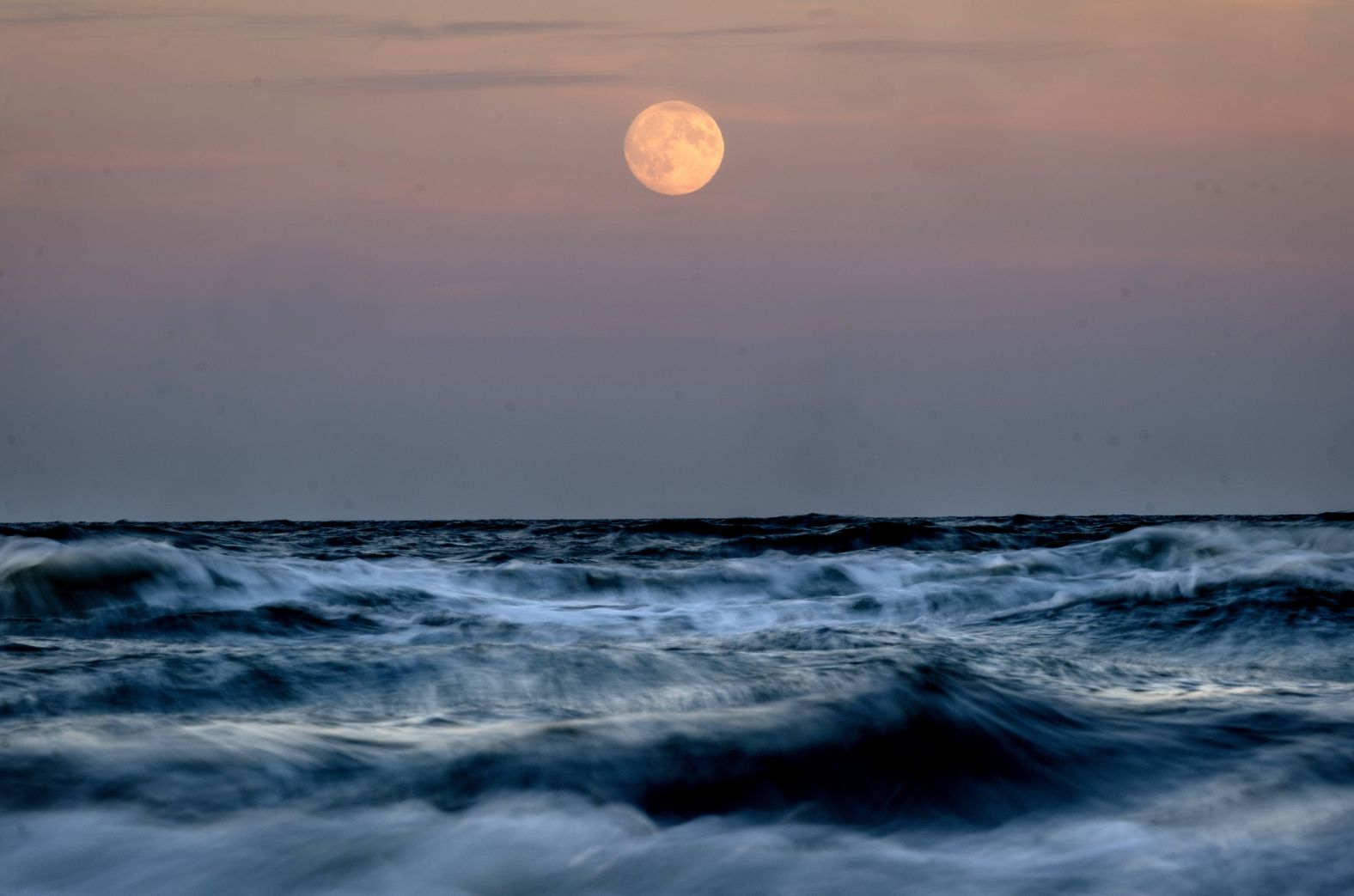 The moon is seen over the Baltic Sea in Haffkrug, Germany, on Wednesday.