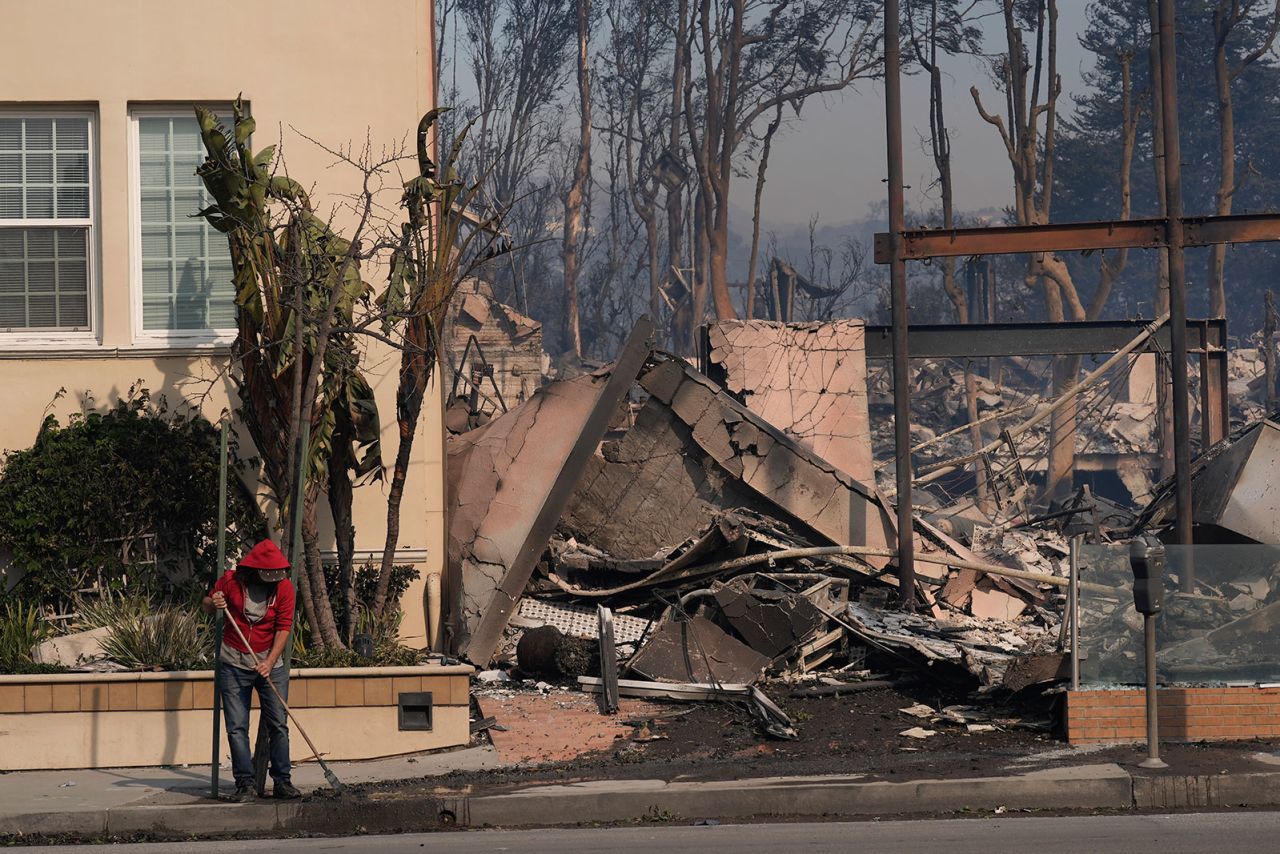 A person begins cleaning up after the Palisades Fire ravaged the Pacific Palisades neighborhood of Los Angeles on January 8.