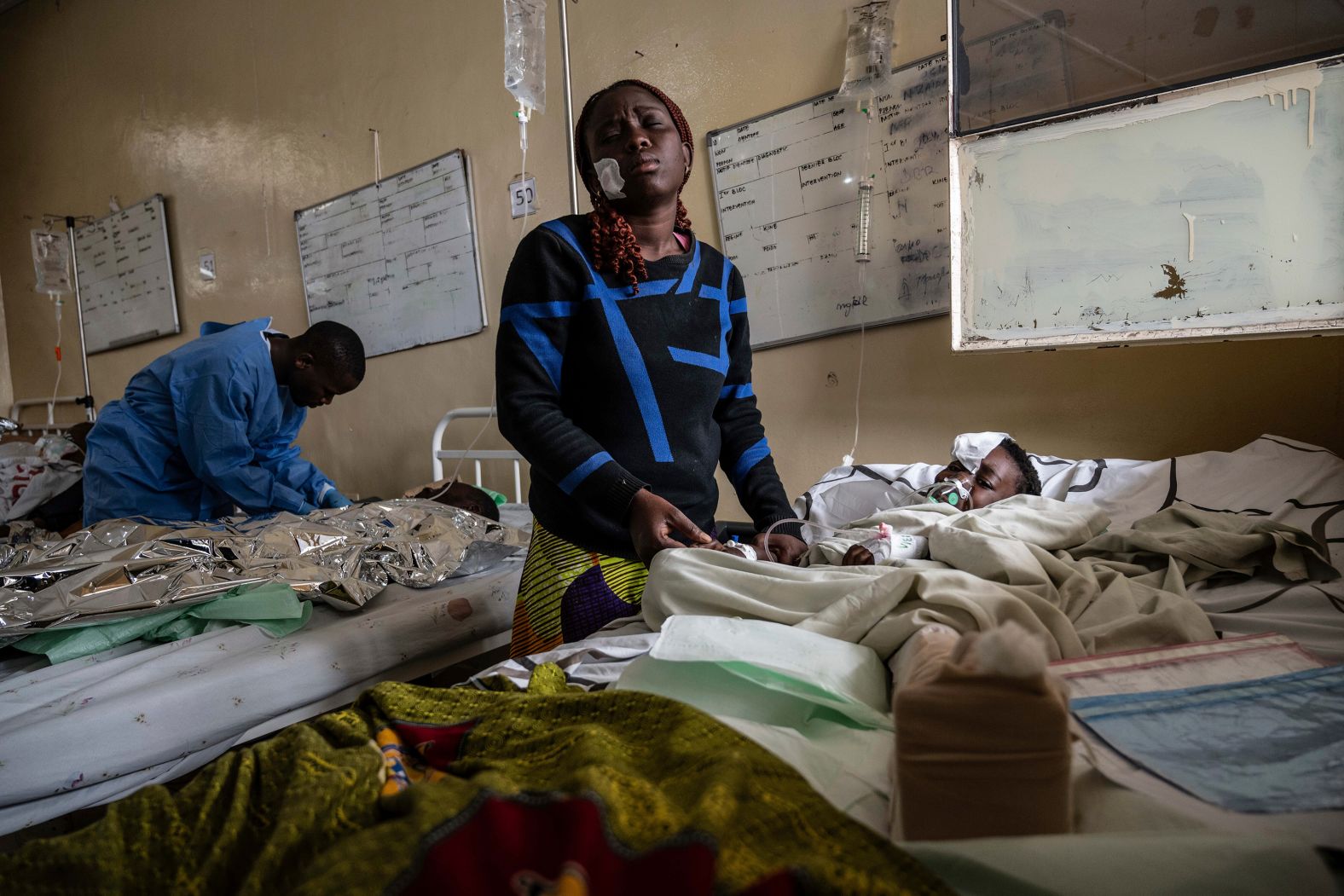 Mariam Nasibu stands by her wounded 10-year-old daughter Deborah in Goma, Democratic Republic of Congo, on Thursday, January 23. Deborah was hurt in <a href="index.php?page=&url=https%3A%2F%2Fwww.cnn.com%2F2025%2F01%2F30%2Fafrica%2Fcongos-tshisekedi-m23-rebels-intl%2Findex.html">the fighting between rebels and Congolese armed forces</a>.