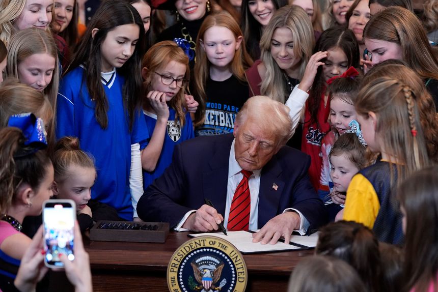 President Donald Trump signs an executive order barring transgender female athletes from competing in women's or girls' sporting events on February 5 at the White House in Washington.