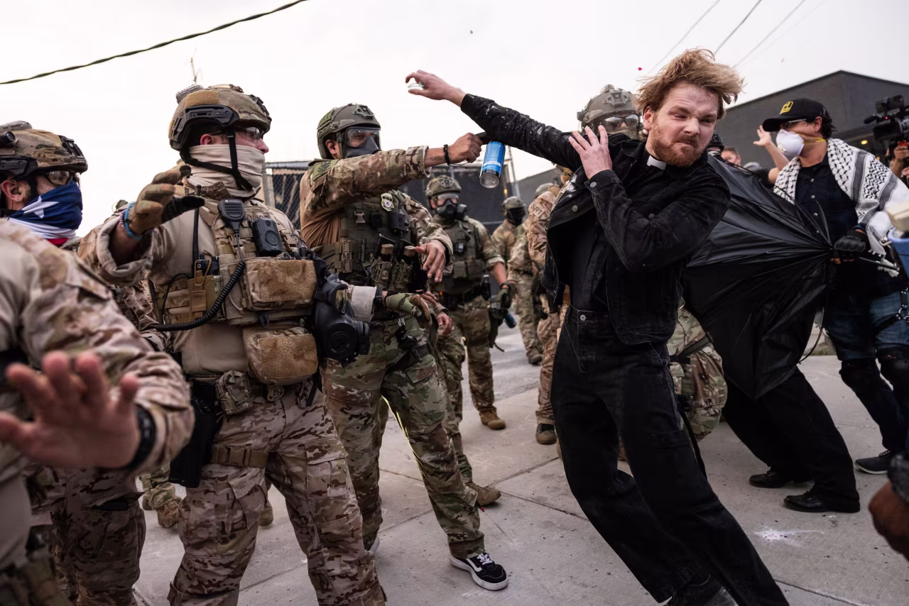 A federal immigration enforcement agent fires pepper balls at Rev. David Black as he and other protesters demonstrate at the Immigration and Customs Enforcement facility in Broadview, Illinois, on September 19.