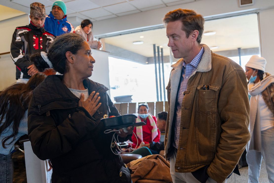 Yorgelis Fabiola, left, apologized to Denver Mayor Mike Johnston, right, for having to enter the US illegally. 