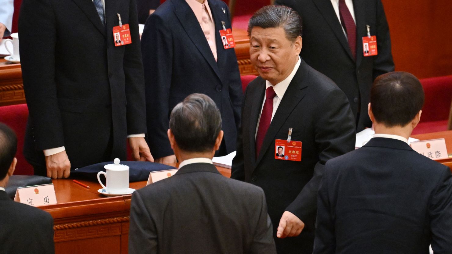 Chinese leader Xi Jinping speaks with top diplomat Wang Yi at the end of the opening session of the National People's Congress on March 5, 2024.