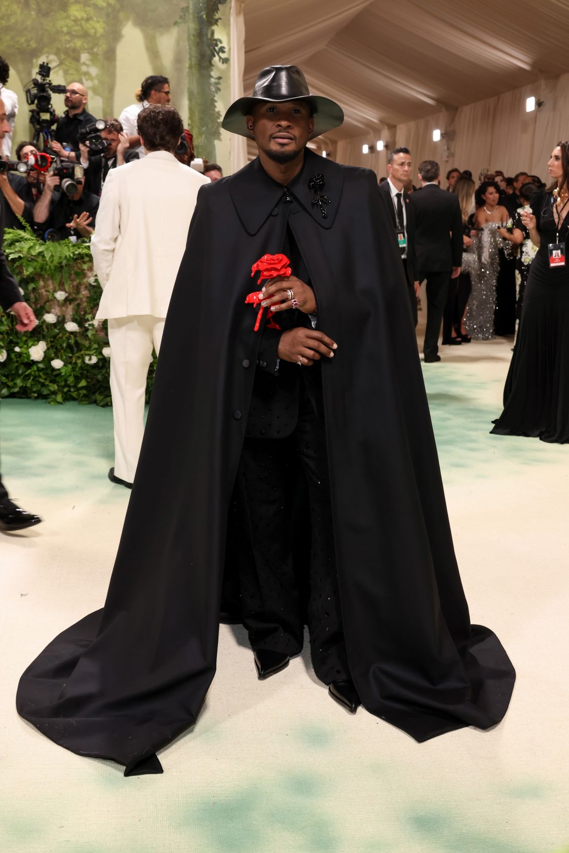 Usher's look was a melancholic take on florals, as he entered holding a singular bleeding rose.