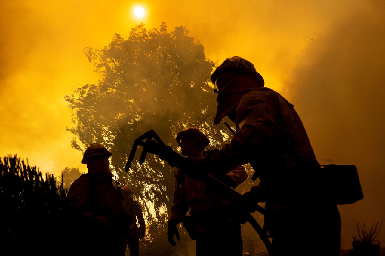 Firefighters put out the flames surrounding a house in Camarillo on Wednesday.