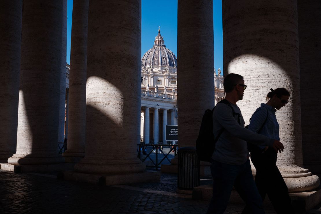 People walk at St. Peter's Square in the Vatican as Francis is hospitalized with pneumonia, on March 6.