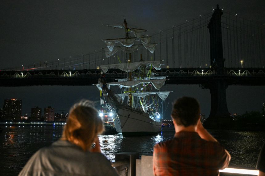 A Mexican Navy training ship floats near the Manhattan Bridge after it slammed Saturday into the nearby Brooklyn Bridge in New York.
