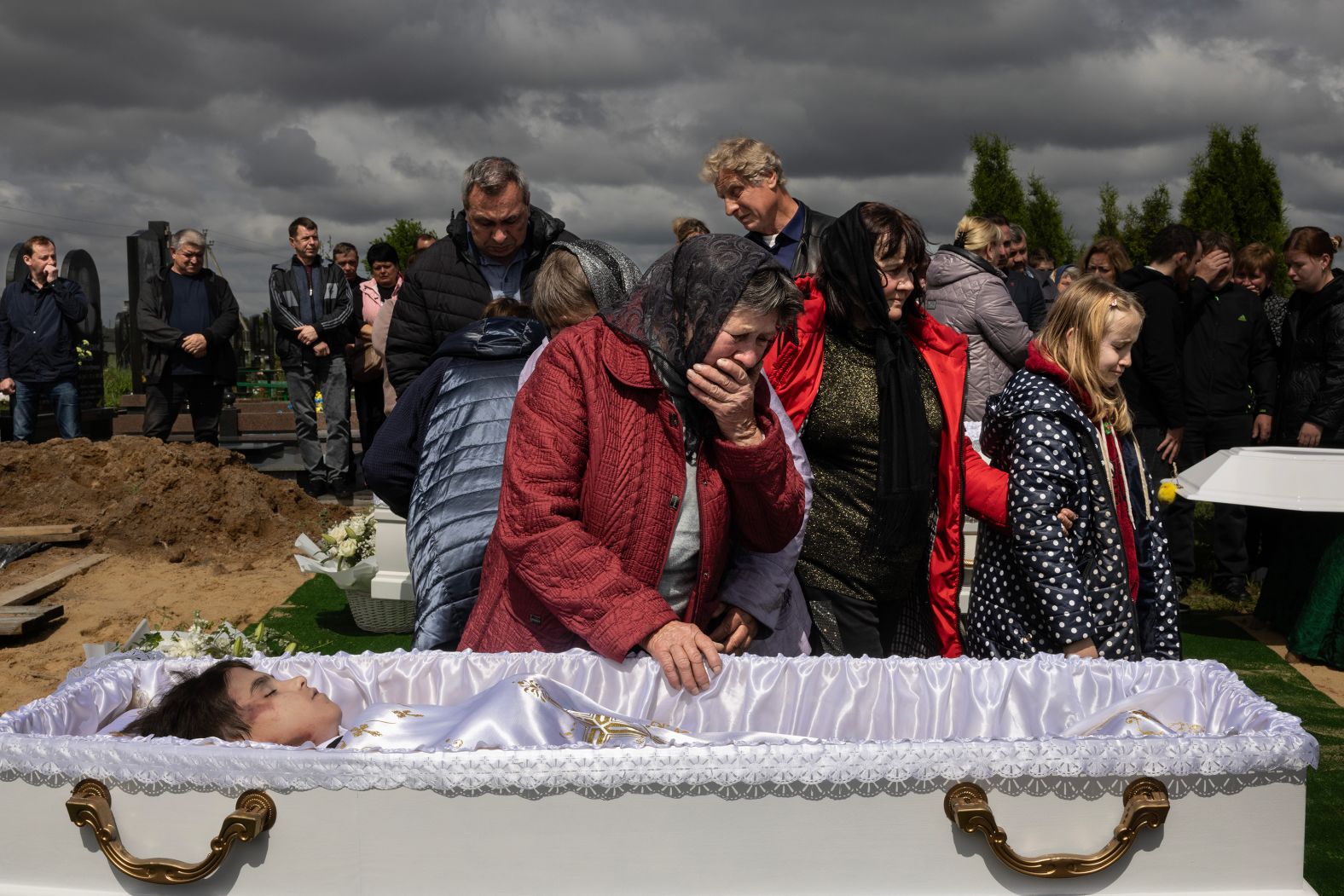 A woman says goodbye to her 17-year-old grandson, Roman Martyniuk, during a funeral in Korostyshiv, Ukraine, on Wednesday, May 28. Martyniuk and his younger siblings Tamara and Stanislav <a href="index.php?page=&url=https%3A%2F%2Fwww.cnn.com%2F2025%2F05%2F27%2Feurope%2Frussia-aerial-terror-ukraine-war-intl">were among those killed in Russian aerial attacks</a> over the weekend.