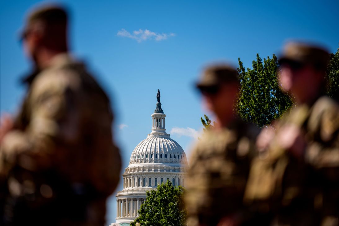 The Dome of the US Capitol Building is visible as armed members of the National Guard stand outside Union Station on August 27.