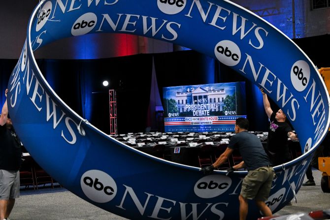 An ABC News banner is assembled as preparations are made in the spin room before the debate.