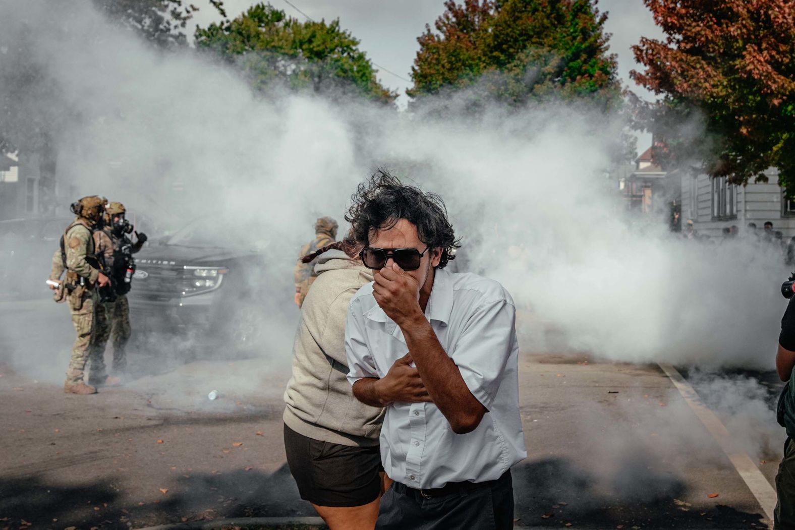 People cover their faces as tear gas is deployed by US Border Patrol agents in Chicago on Tuesday, October 14. Agents pursued and crashed into a vehicle as part of an immigration enforcement operation on Tuesday, leading to an angry response from community residents and the deployment of tear gas in Chicago’s far southeast side. <a href="index.php?page=&url=https%3A%2F%2Fwww.cnn.com%2F2025%2F10%2F14%2Fus%2Fchicago-ice-protesters-crash">The tense standoff</a> exemplifies tensions in Chicago over immigration enforcement as the Trump administration is trying to move National Guard troops into the Windy City.