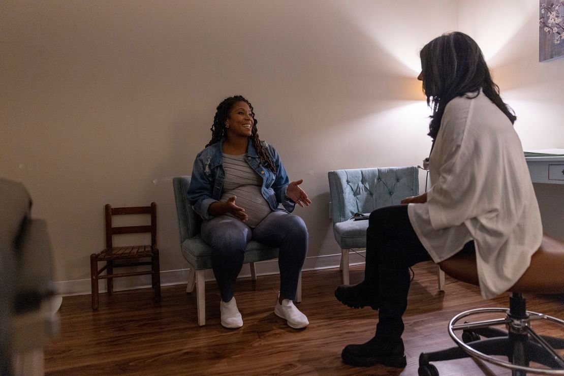 Kunz (left) speaks with midwife Anjili Hinman, whom she visited in November.