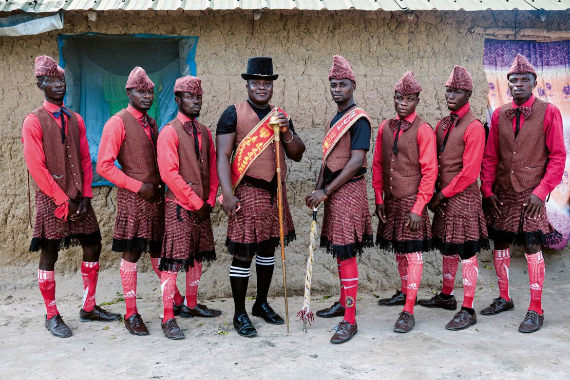 Benjamin Aidoo (center, in black hat) poses alongside some of his dancers in their “Scottish Red” uniform in 2022. Tschumi calls Aidoo one of her best friends, and a key figure in opening doors for her to document Ghana’s unique funeral traditions.