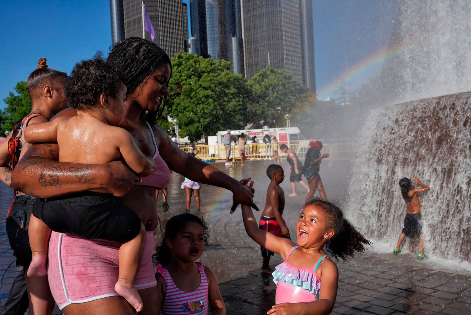 Kiara Daniels holds her son Kayson while twirling her daughter, Kehlani, at the Dodge Fountain in downtown Detroit’s Hart Plaza on Monday, June 23. They were waiting for the start of a fireworks show.