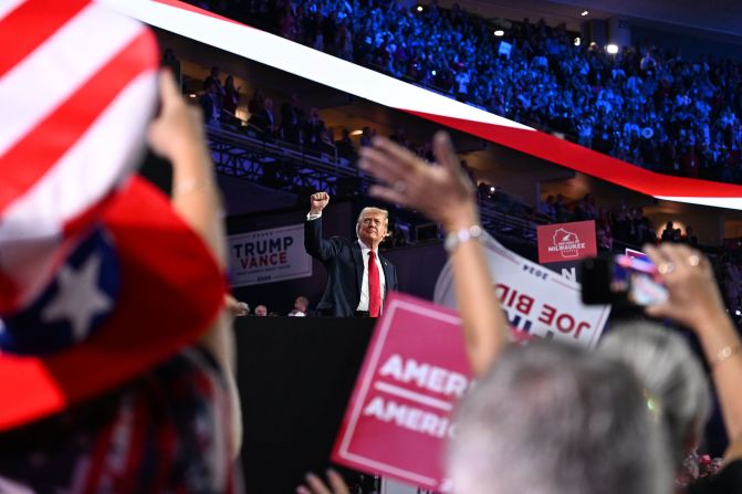 Former President Donald Trump raises his fist during the <a href=