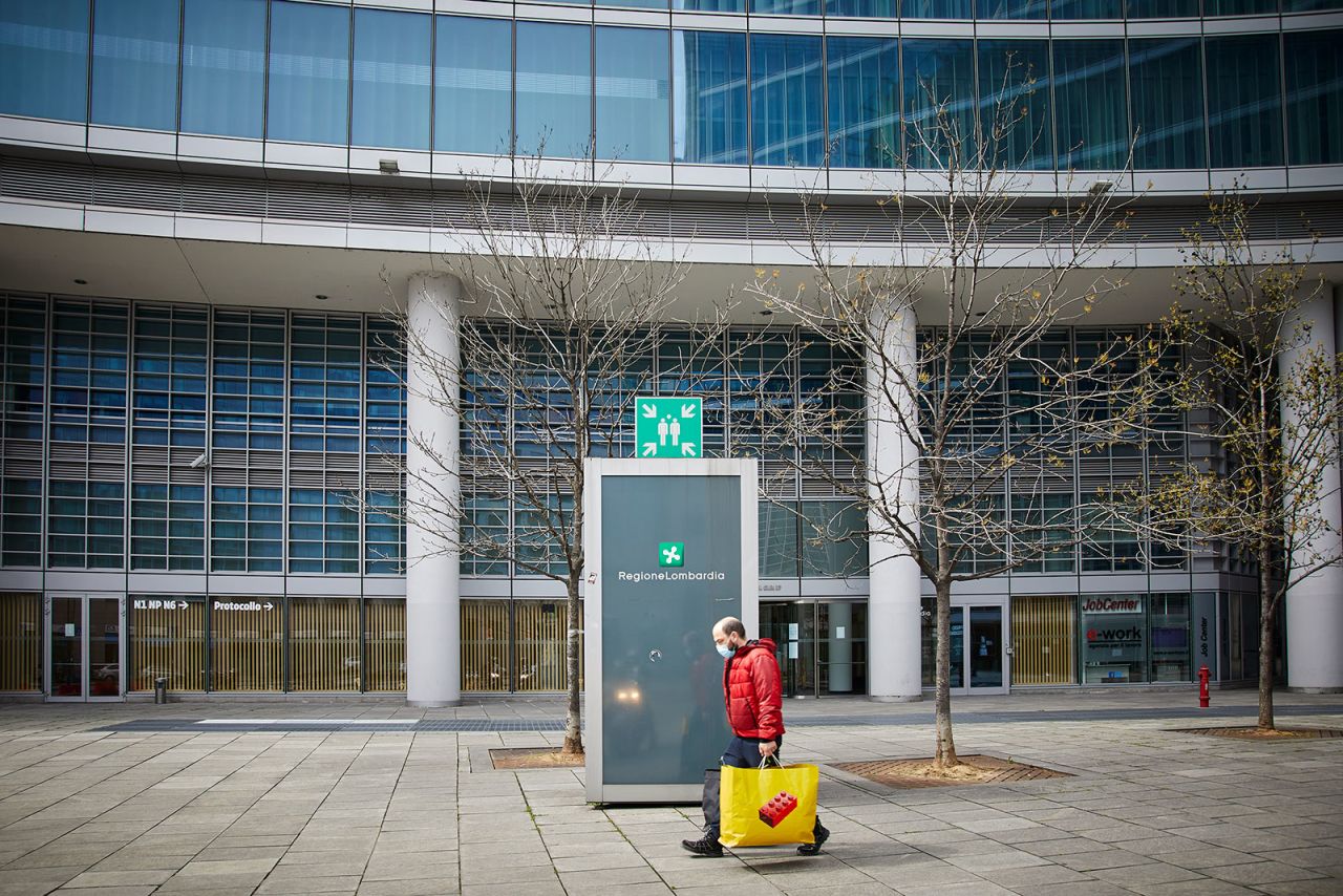 A man walks with groceries in Milan, Italy, on April 2.