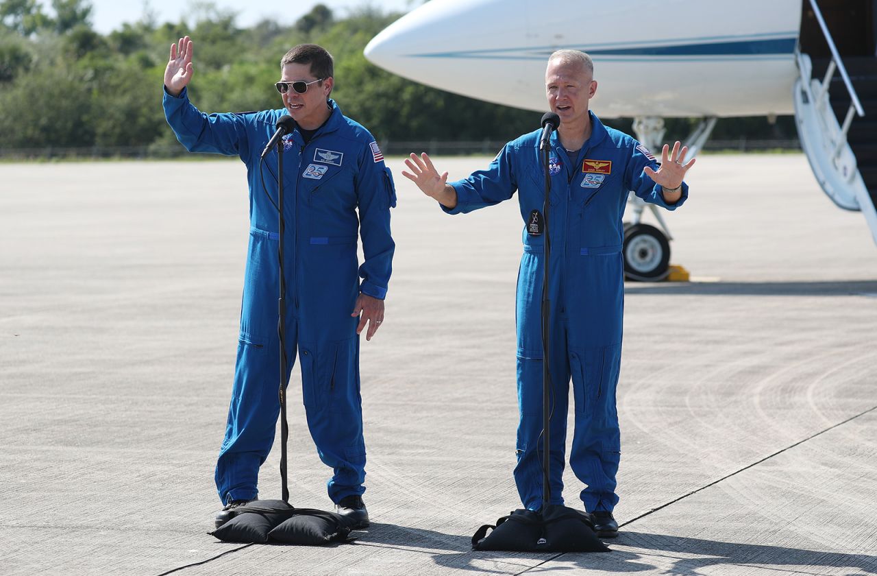 NASA astronauts Bob Behnken, left, and Doug Hurley speak to the media after arriving at the Kennedy Space Center on May 20, in Cape Canaveral, Florida.