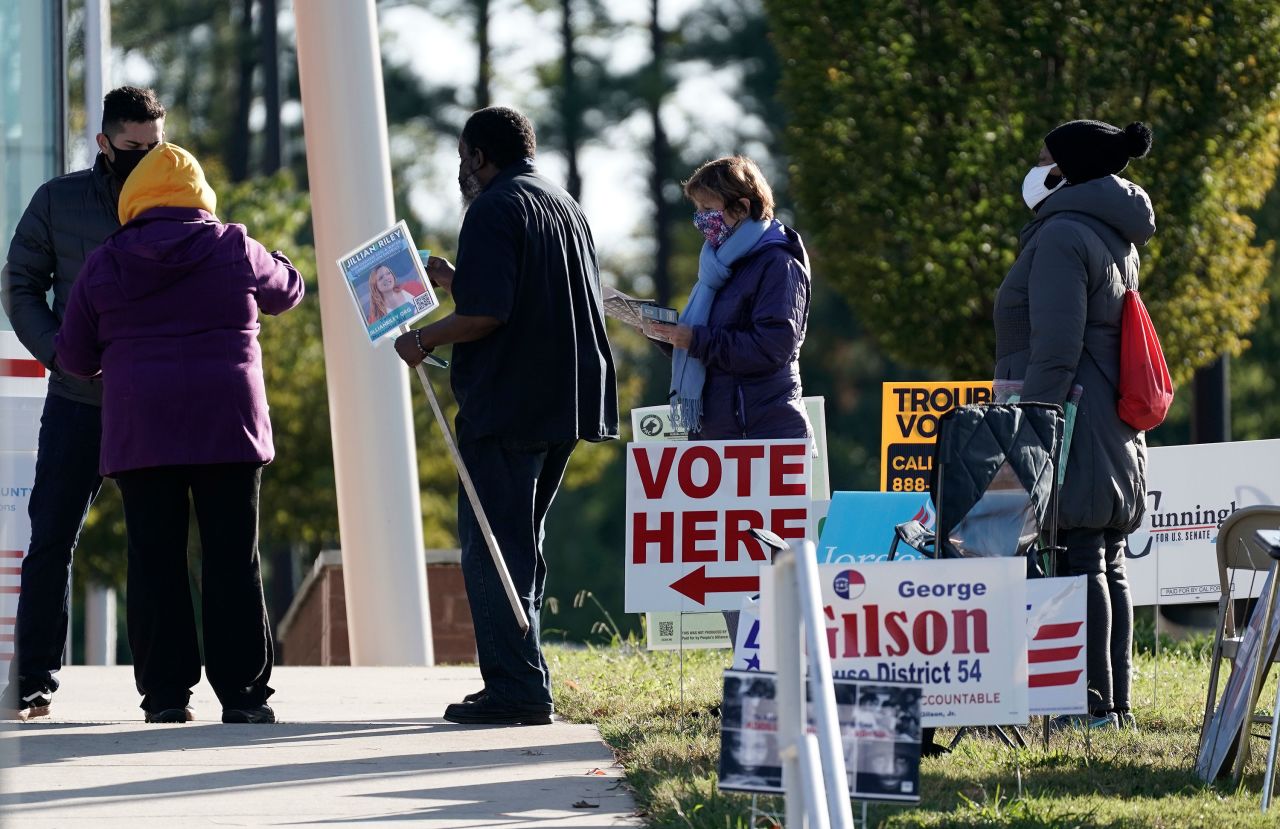 Voters wait in line at a polling location in Durham, North Carolina on Tuesday, November 3.