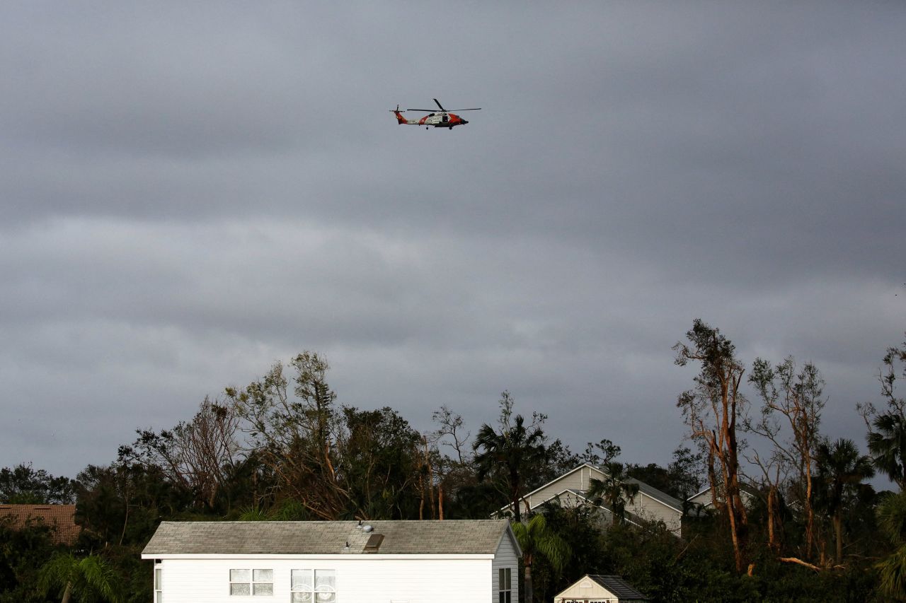 A helicopter flies over part of Fort Myers, Florida, on Thursday.
