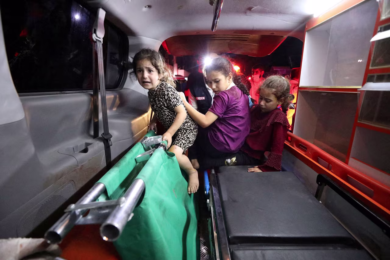 Children sit in the back of an ambulance at Al-Shifa Hospital in Gaza City following a blast at Al-Alhi Baptist Hospital on October 17.