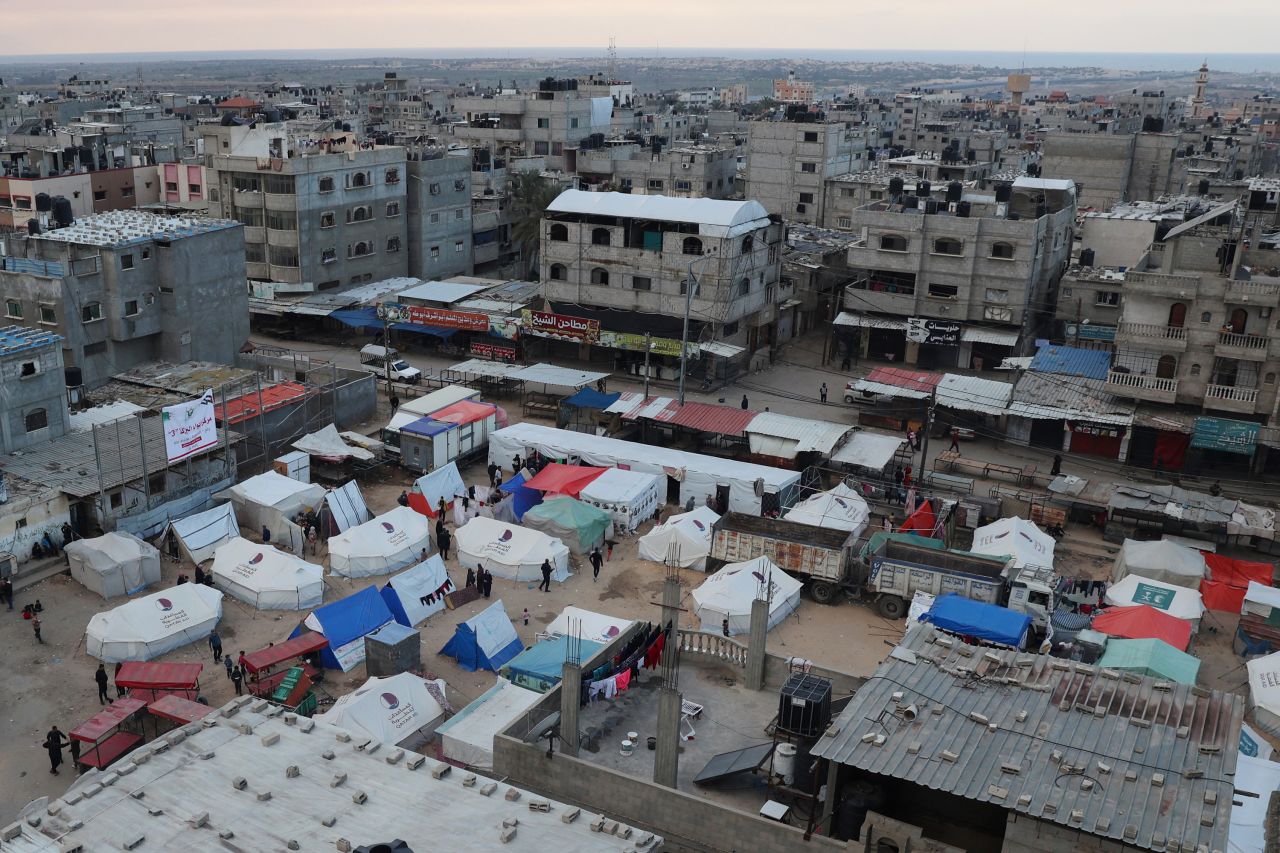 Displaced Palestinians stand outside their tents in Rafah, Gaza on February 14.