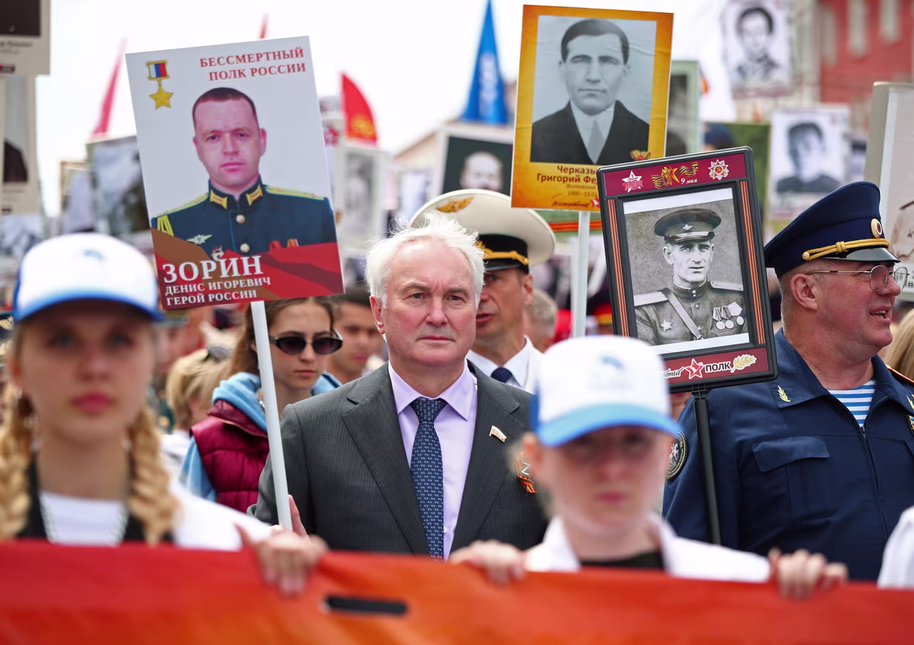 Chairman of the Committee on Defence of Russia's State Duma Andrei Kartapolov, center, takes part in the Immortal Regiment march on Victory Day in Volgograd, Russia, on May 9.