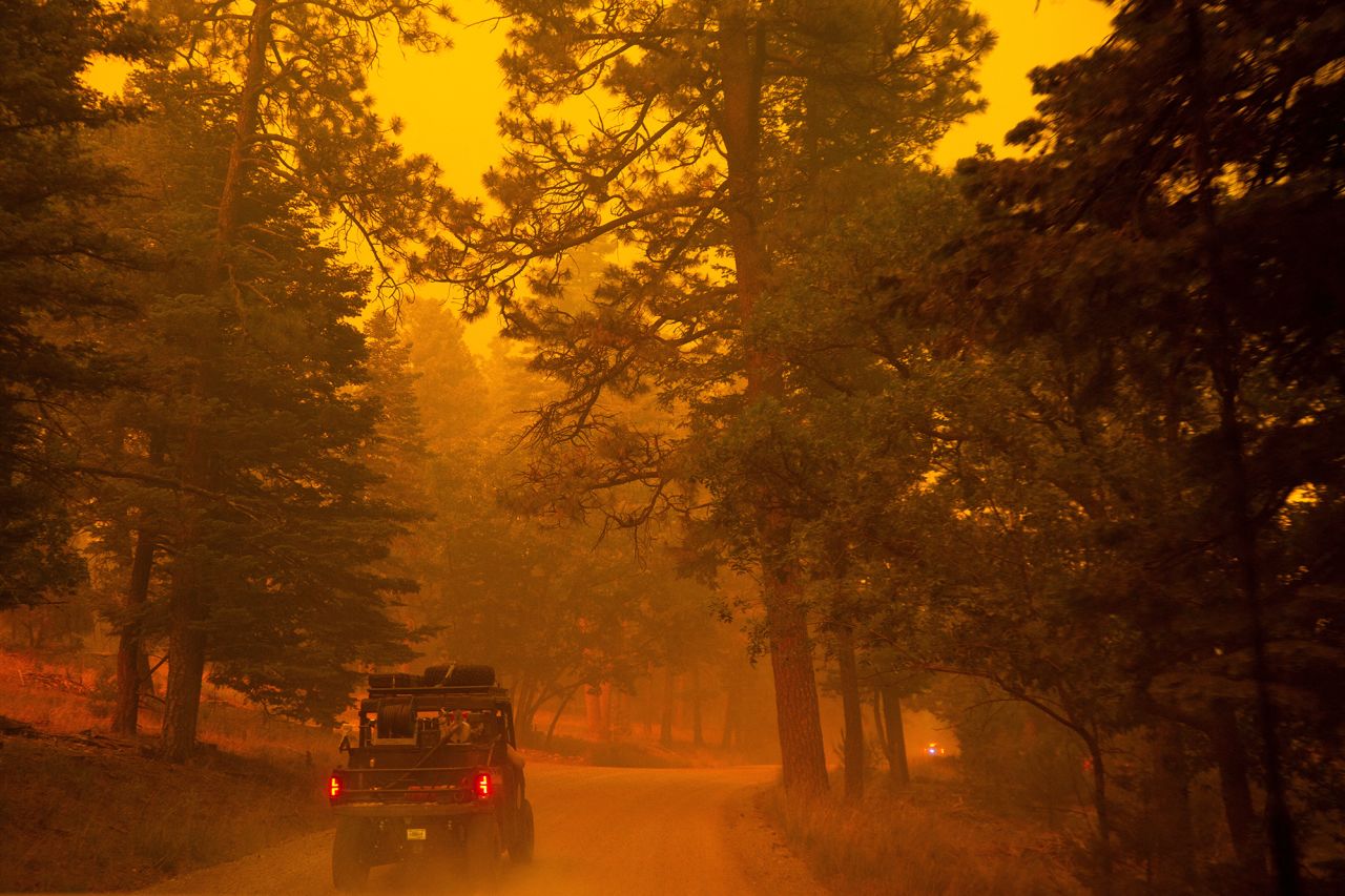 Smoke from the South Fork Fire covers the sun, casting an orange light across the Lincoln National Forest at Cedar Creek, in Ruidoso, New Mexico, on June 17.