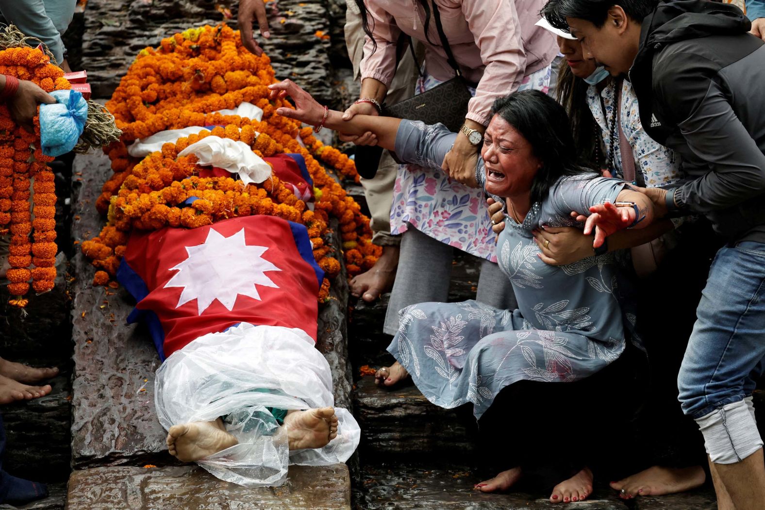 The mother of Rashik Khatiwad mourns her daughter during cremation rituals in Kathmandu, Nepal, on Tuesday, September 16. Khatiwad, 23, died last week during <a href="index.php?page=&url=https%3A%2F%2Fwww.cnn.com%2F2025%2F09%2F09%2Fasia%2Fnepal-protests-social-media-ban-explainer-intl-hnk">the deadliest social unrest Nepal has seen in years</a>.