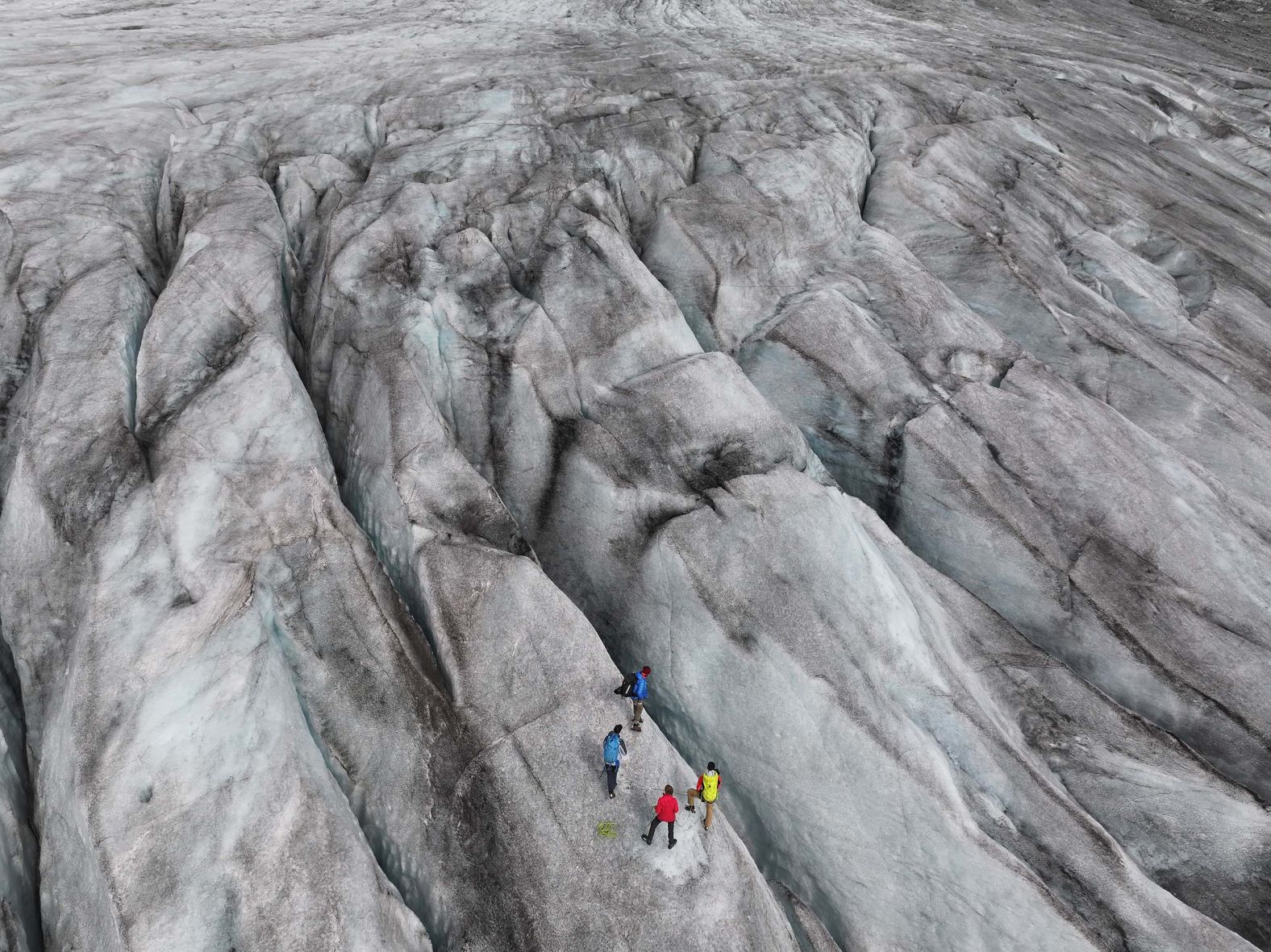 A scientific team from the Swiss Federal Institute of Technology in Zurich stands among crevasses on the Rhône Glacier while collecting data near Gletsch, Switzerland, on Friday, August 22. The Rhône Glacier, among Switzerland’s largest, is likely facing another withering year following record-breaking temperatures across Europe in June and overall low levels of snowfall.