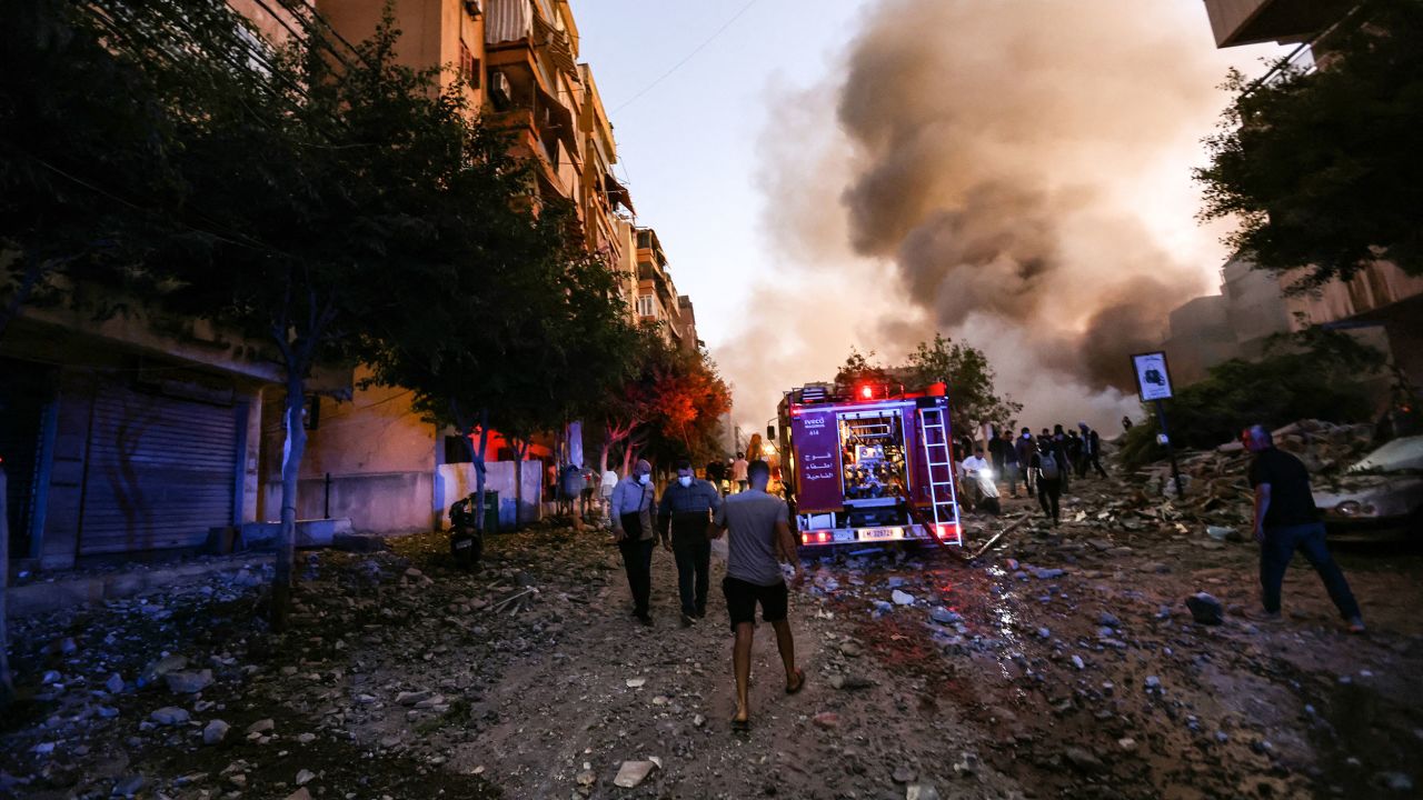 People and a fire truck rush to the scene of the strike.