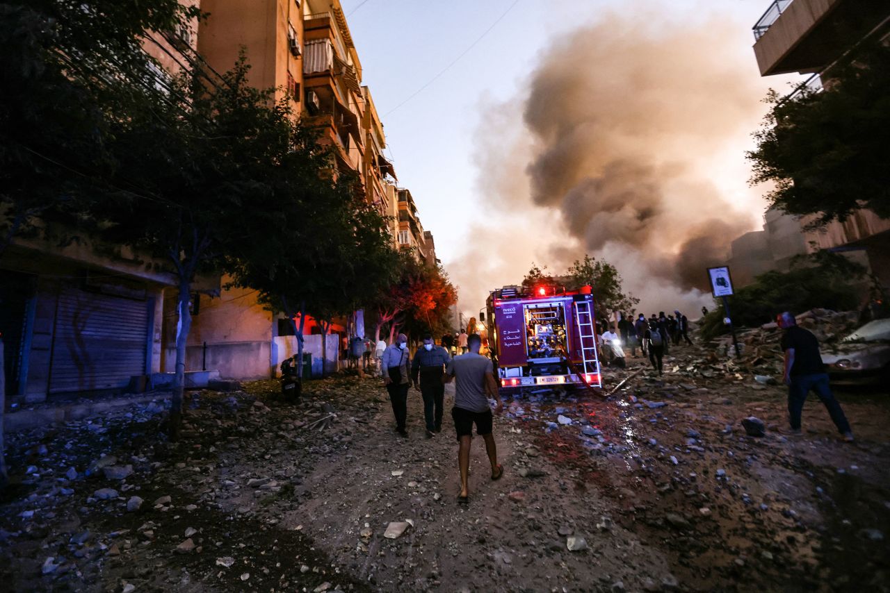 People and a fire truck rush to the scene of the strike.