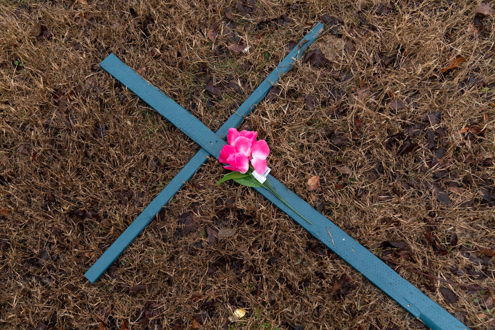 A flower rests on a cross at the makeshift memorial in Arlington, Virginia.