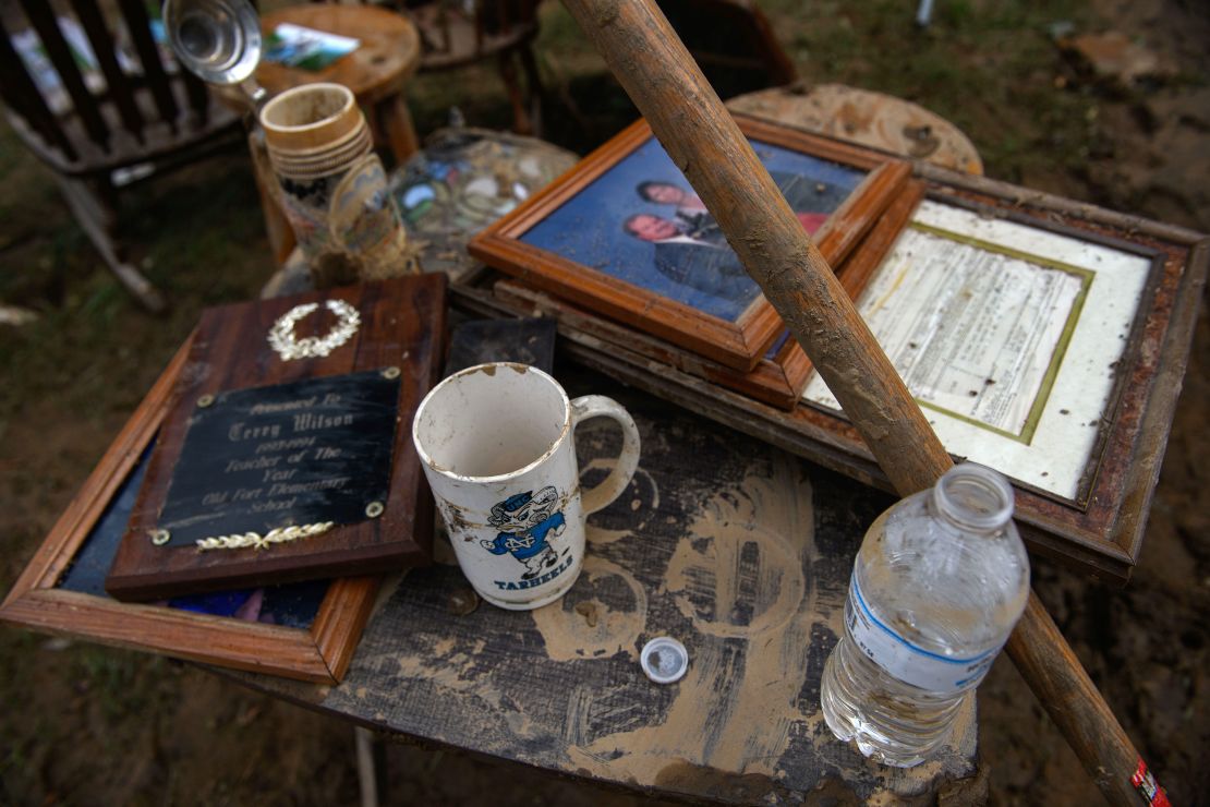 Terry Wilson's keepsakes lay Sunday outside his mother's home in Old Fort, North Carolina. Their beloved dog's ashes were found after the flooding, Wilson said.