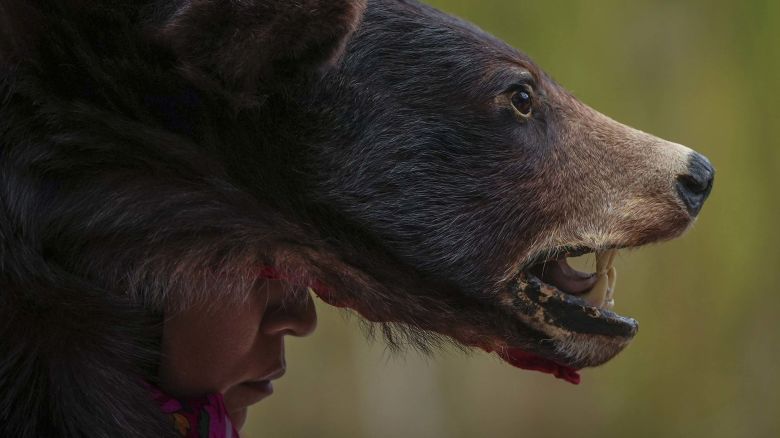 Aileen Michel (L'il Bear) wears a bear hide as she listens before performing a bear dance during a gathering to mark the National Day for Truth and Reconciliation, in Vancouver, British Columbia, Tuesday, Sept. 30, 2025. (Darryl Dyck/The Canadian Press via AP)