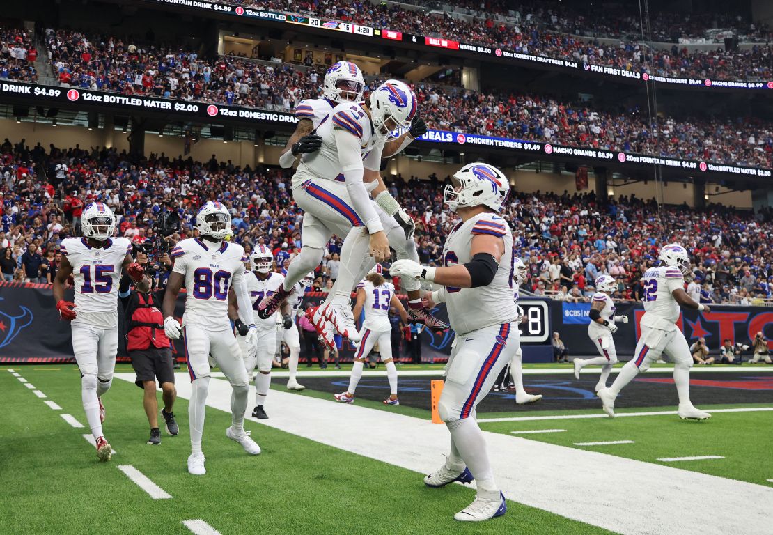 Bills players celebrate in front of the crowd.