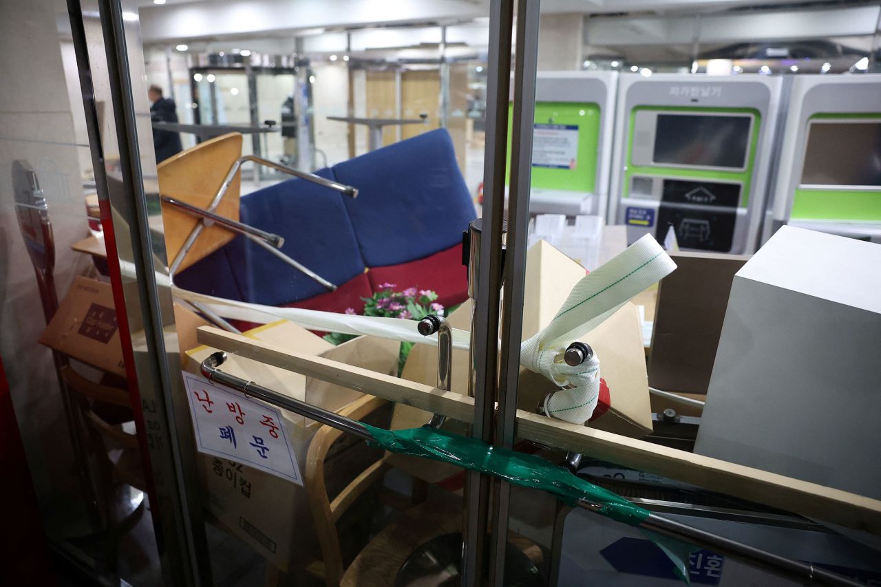 Furniture and boxes are piled up to barricade the entrance doors of the National Assembly.