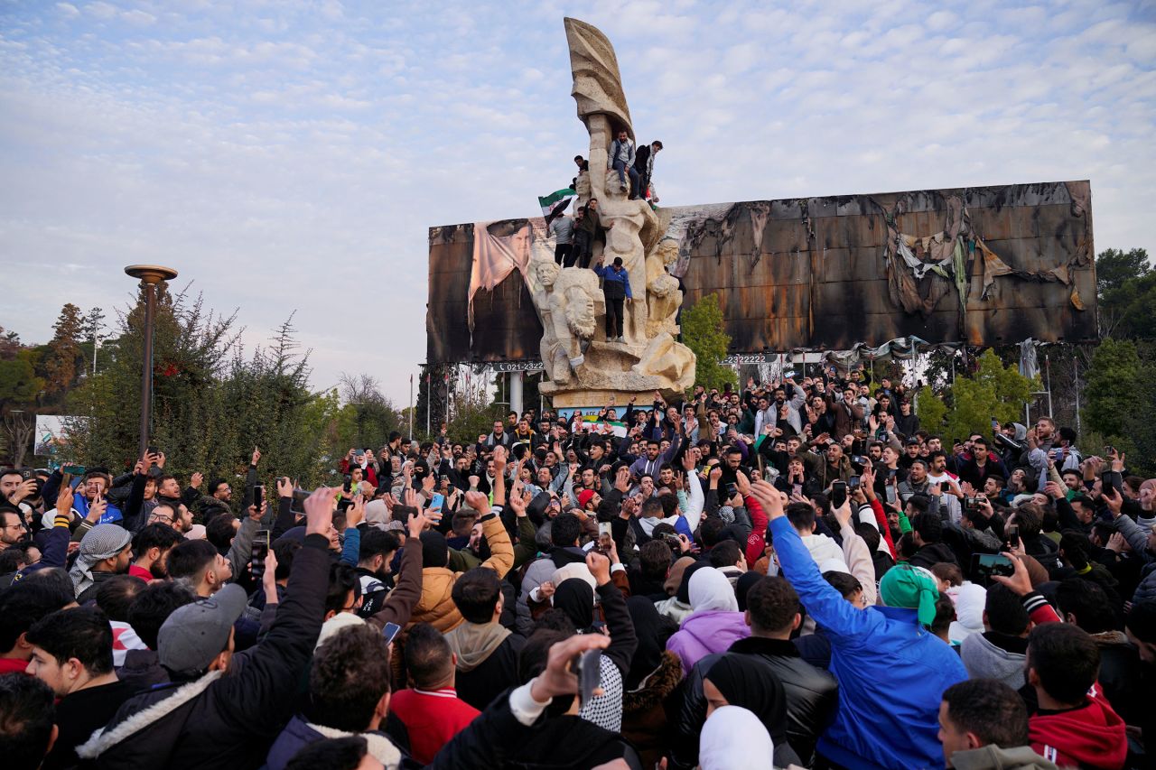 People gather to celebrate at Saadallah al-Jabiri Square in Aleppo, on December 8, following the rebels' offensive moving into Damascus.