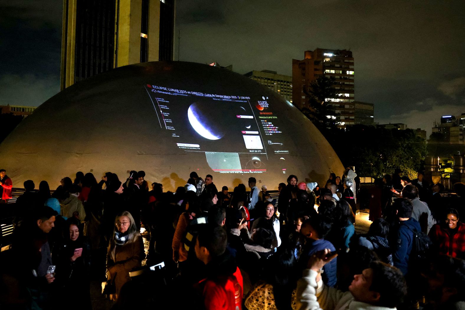 People gather on the roof of a planetarium in Bogota, Colombia, to watch the lunar eclipse.