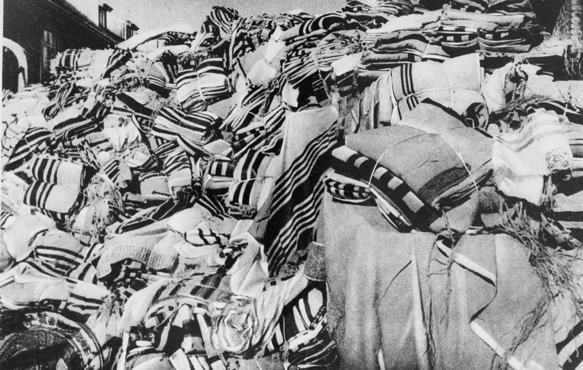 A large pile of prayer shawls, confiscated by the Nazis from arriving prisoners, are seen stored in one of the warehouses in Auschwitz.