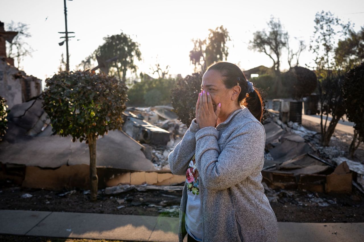 Crystal Dedeaux walks up the driveway of her childhood home for the first time since she and her mother evacuated the fire. She says, "I'm just flabbergasted."