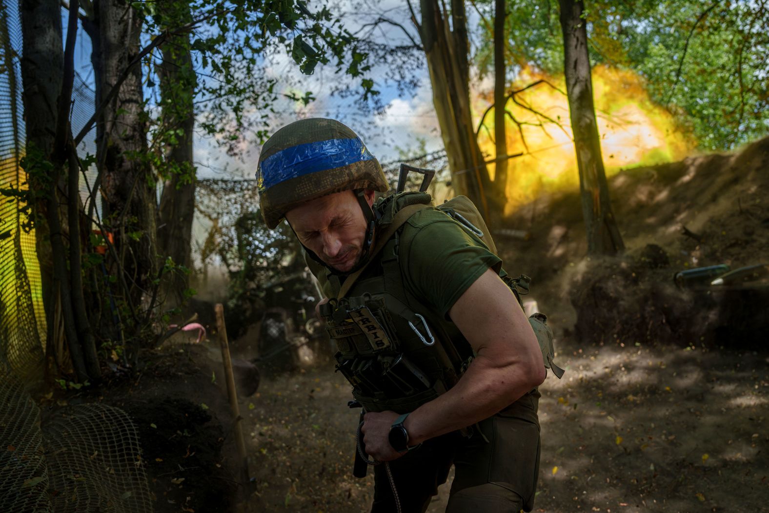 A Ukrainian serviceman fires a cannon toward Russian positions near Kharkiv, Ukraine, on Monday, June 10.