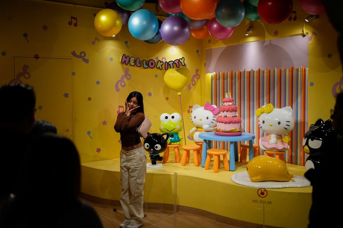 A fan poses for photos at a Hello Kitty-themed cafe in Mexico City.