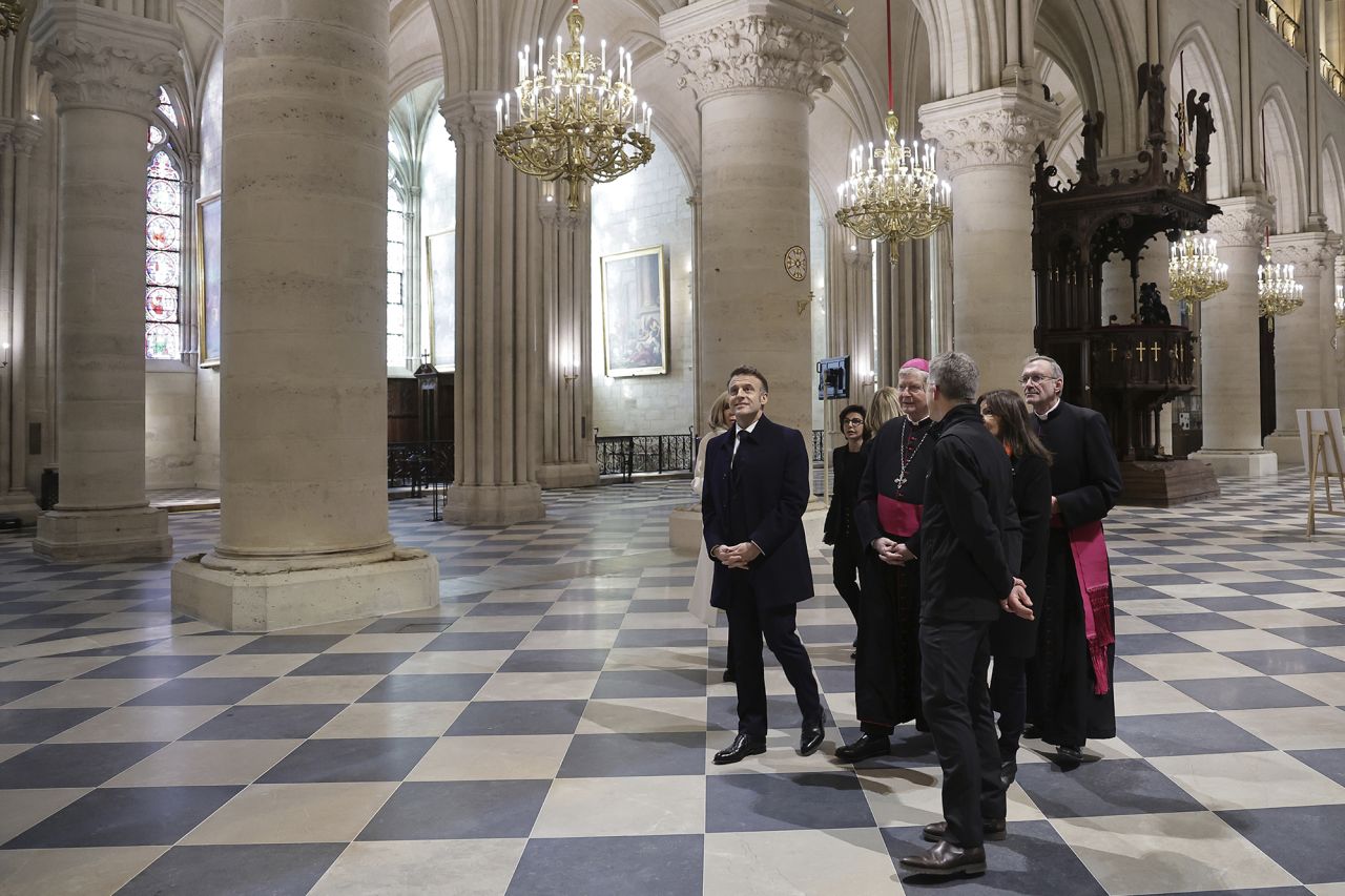 French President Emmanuel Macron visits the restored interiors of Notre Dame cathedral.