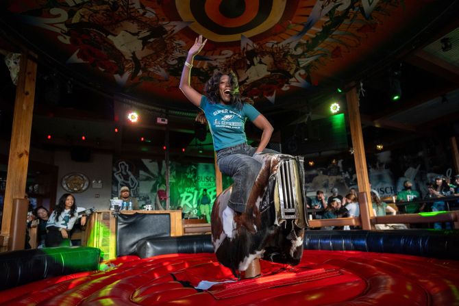 An Eagles fan rides a mechanical bull while attending a watch party at a Philadelphia bar.