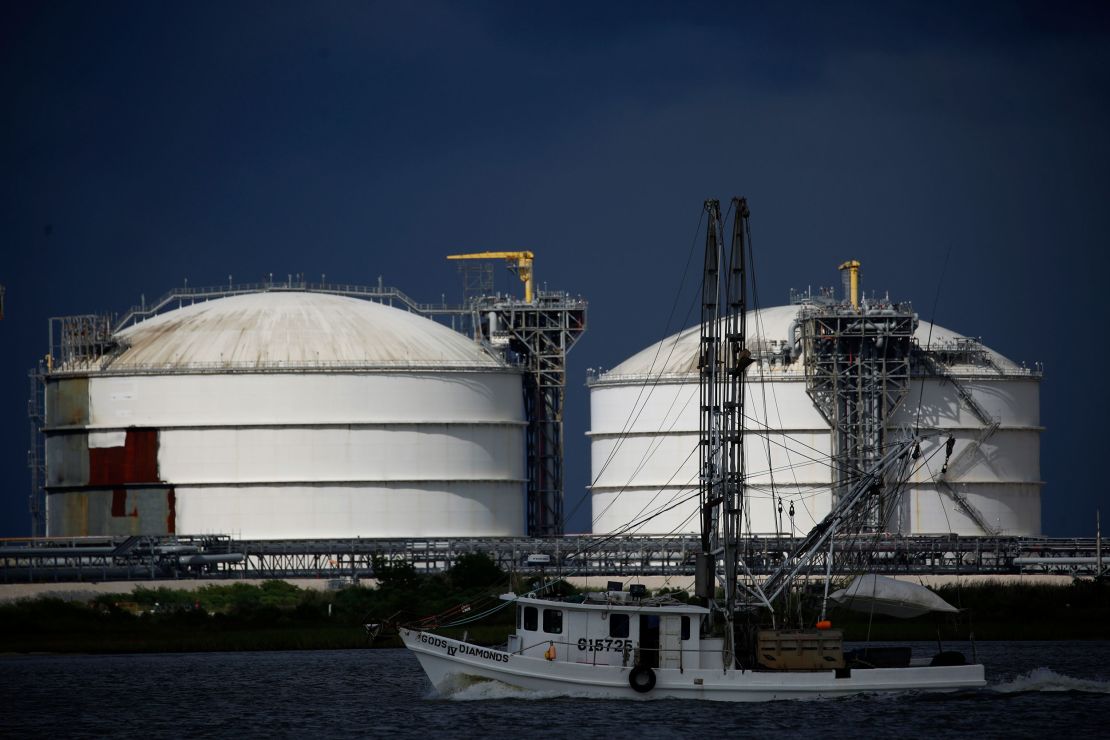 A shrimp boat passes by storage tanks at the Sabine Pass LNG Export Terminal ahead of Hurricane Laura in Sabine Pass, Texas, in August 2020.