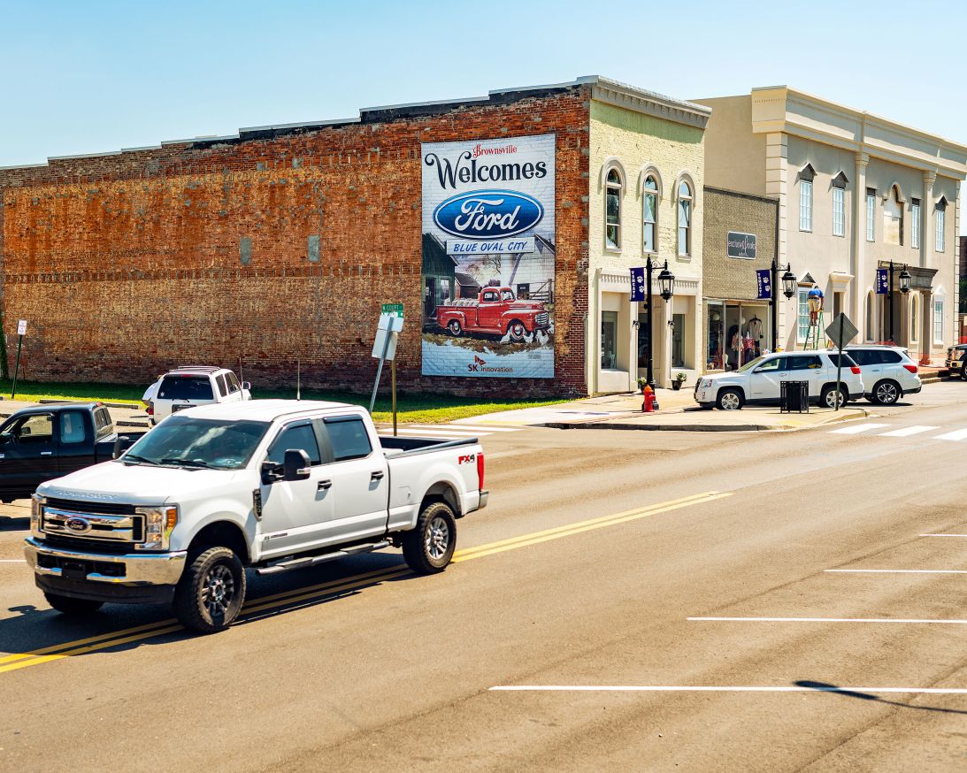 A mural reads "Brownsville Welcome Ford BlueOval City" in Brownsville, Tennessee, US, on Tuesday, Sept. 20, 2022. Ford Motor Co.'s $5.6 billion manufacturing complex, known as BlueOval City, is due to begin building electric F-Series pickup trucks and the batteries that power them in three years. Photographer: Houston Cofield/Bloomberg via Getty Images