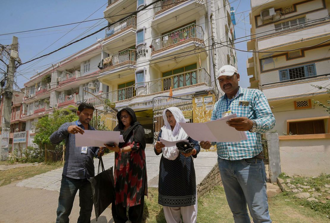 Enumerators receive information from residents during Bihar's state-wide caste survey in the Rajendra Nagar neighborhood of Patna, in April 2023.